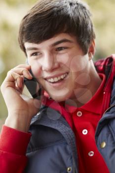 Teenage Boy Talking On Smartphone Wearing Winter Clothes