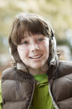Boy Wearing Headphones And Listening To Music Wearing Winter Clothes