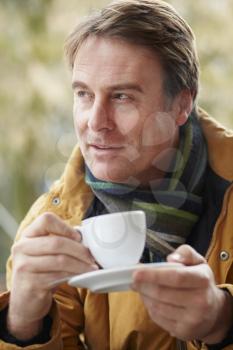 Man In Outdoor Caf With Hot Drink  Wearing Winter Clothes