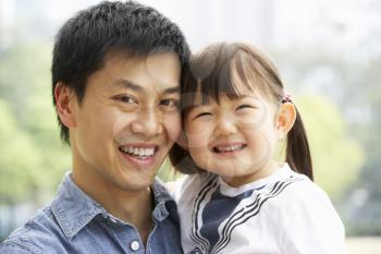 Portrait Of Chinese Father With Daughter In Park
