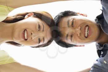 Young Chinese Couple Looking Down Into CameraTogether