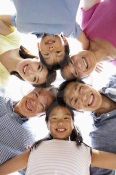 Portrait Of Multi-Generation Chinese Family Looking Down Into Camera