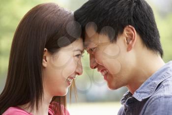 Portrait Of Young Chinese Couple Looking At Each Other