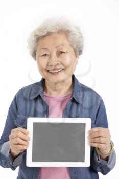 Studio Shot Of Chinese Senior Woman Holding Digital Tablet