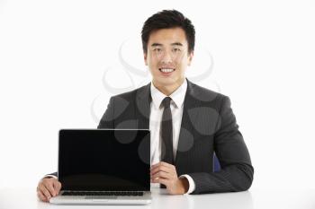 Studio Shot Of Chinese Businessman Working On Laptop