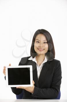 Studio Shot Of Chinese Businesswoman Working On Tablet Computer