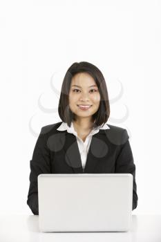 Studio Shot Of Chinese Businesswoman Working On Laptop