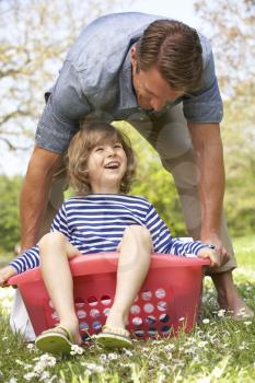 Father Carrying Son Sitting In Laundry Basket