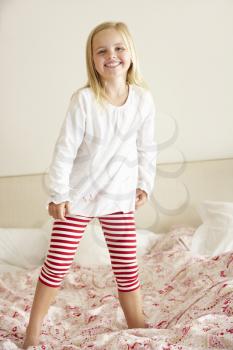 Young Girl Bouncing On Bed