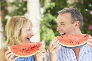 Senior Couple Enjoying Slices Of Water Melon