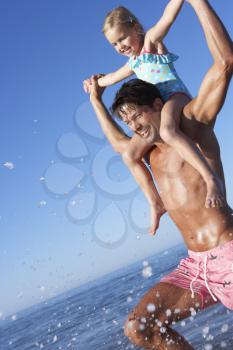 Father And Daughter Having Fun On Beach
