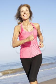 Senior Woman Exercising On Beach