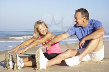 Senior Couple Exercising On Beach