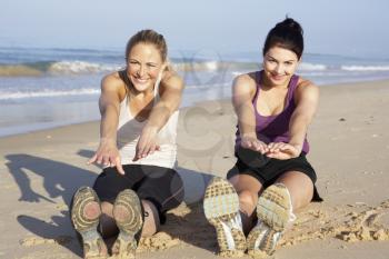 Two Women Exercising On Beach