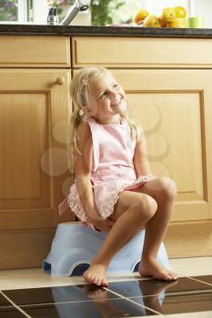 Girl Sitting On Plastic Step In Kitchen