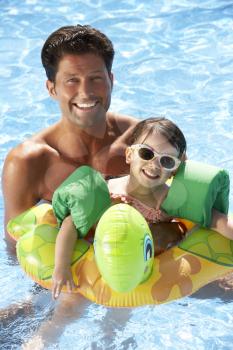 Father And Daughter Having Fun In Swimming Pool