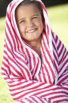 Girl Wrapped In Towel Sitting In Garden