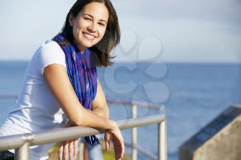 Hispanic Woman Looking Over Railing At Sea