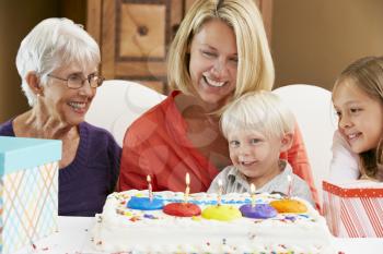 Family Celebrating Children's Birthday With Grandmother