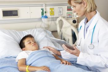 Doctor Using Digital Notepad Whilst Visiting Child Patient