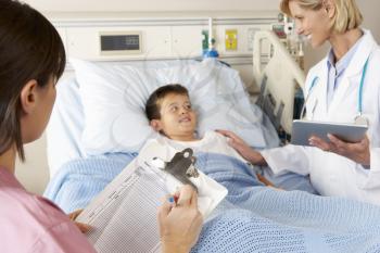 Doctor Using Digital Notepad Whilst Visiting Child Patient