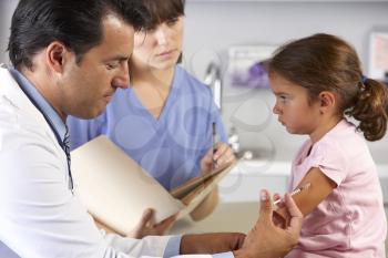 Doctor Giving Child Injection In Doctor's Office