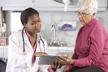 Doctor Discussing Records With Senior Female Patient