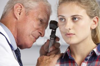Doctor Examining Teenage Girl's Ears