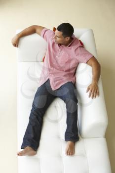 Overhead View Of Man Relaxing On Sofa