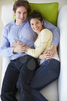 Overhead View Of Couple Relaxing On Sofa