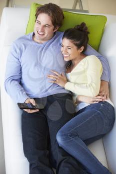 Overhead View Of Couple Watching TV On Sofa