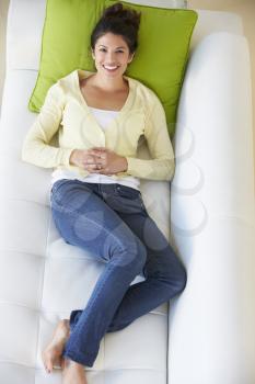 Overhead View Of Woman Relaxing On Sofa