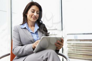 Businesswoman Using Digital Tablet In Office