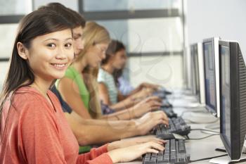 Group Of Students Working At Computers In Classroom