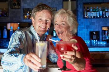 Senior Couple Enjoying Cocktail In Bar