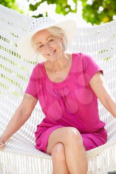 Senior Woman Relaxing In Beach Hammock