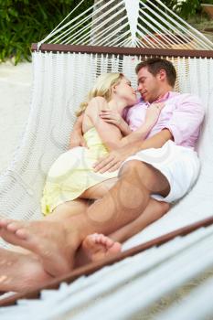 Couple Sleeping In Beach Hammock