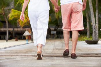 Detail Of Senior Couple Walking On Wooden Jetty