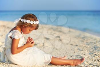 Bridesmaid Sitting On Beach At Wedding Ceremony