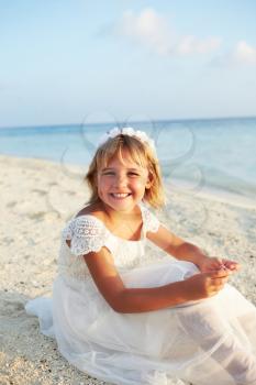 Bridesmaid Sitting On Beach At Wedding Ceremony