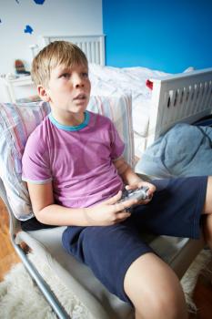 Boy Holding Controller Playing Video Game