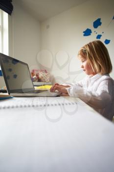 Girl Using Laptop In Bedroom