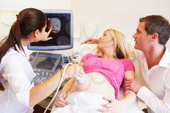 Pregnant Woman And Partner Having 4D Ultrasound Scan