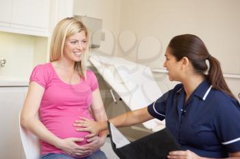 Pregnant Woman Being Given Ante Natal Check By Nurse
