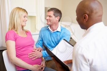 Couple Meeting With Obstetrician In Clinic