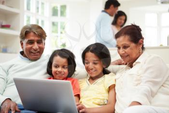Multi-Generation Indian Family With Laptop