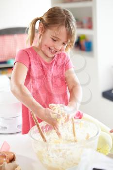 Girl Making Cupcakes In Kitchen