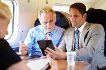 Two Businessmen Having Meeting On Train