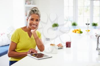 African American Woman Using Digital Tablet At Home