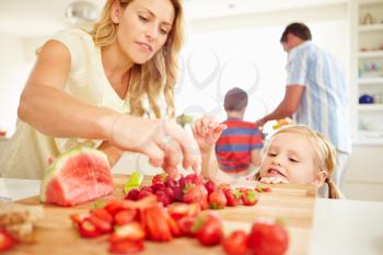 Daughter Helping Mother To Prepare Family Breakfast